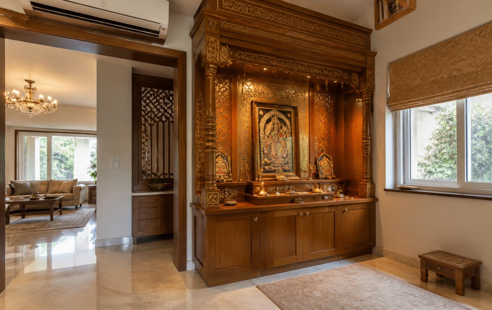 Grand gold and teak home pooja mandir temple in cream marble by Sri Durga Interiors